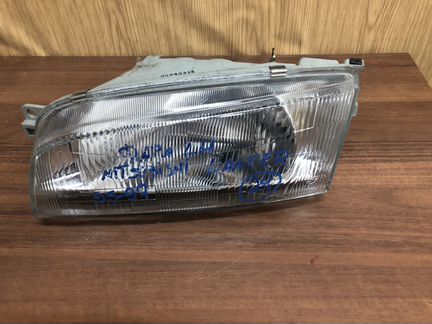 Фара левая Mitsubishi Lancer